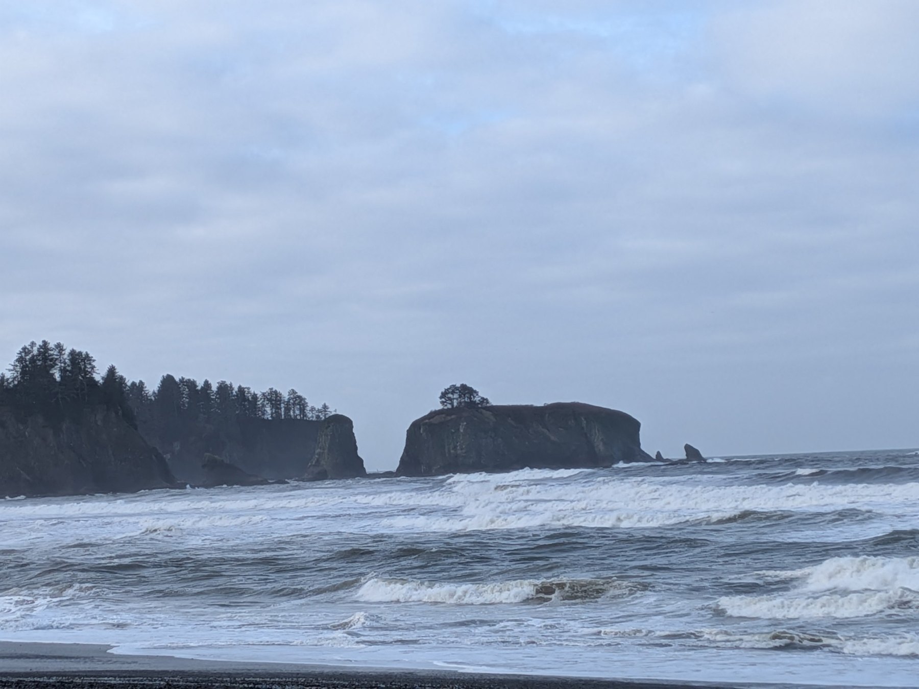Stormy ocean coastline with waves and rocky islands